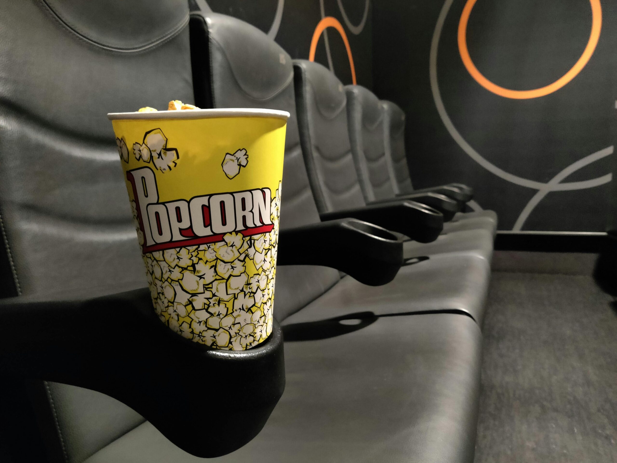 A meme showing a movie-goer holding a bowl of popcorn with a dramatic caption: "Popcorn cost more than the movie ticket now. Is this even legal?"